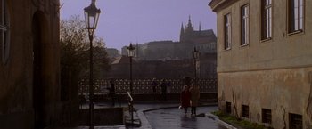 Movie still from “Mission: Impossible” (1996), directed by Brian De Palma – People walking on a bridge in front of a castle; Extreme Wide shot, High angle