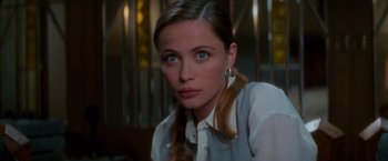 Movie still from “Mission: Impossible” (1996), directed by Brian De Palma – A person wearing a white shirt; Close Up shot, Over the shoulder angle