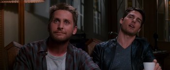 Movie still from “Mission: Impossible” (1996), directed by Brian De Palma – Two men sitting next to each other in a room; Close Up shot, Over the shoulder angle