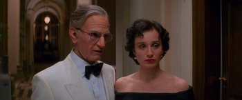 Movie still from “Mission: Impossible” (1996), directed by Brian De Palma – An older man and a young woman standing next to each other; Close Up shot, Low angle