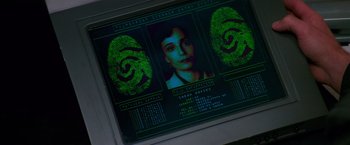 Movie still from “Mission: Impossible” (1996), directed by Brian De Palma – A computer screen showing a woman's face and fingerprints on it; Extreme Close Up shot, Overhead angle