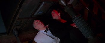 Movie still from “Mission: Impossible” (1996), directed by Brian De Palma – A man and a woman looking up at the ceiling; Medium shot, Overhead angle