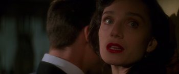 Movie still from “Mission: Impossible” (1996), directed by Brian De Palma – A woman's face and a man's face in the background; Close Up shot, Over the shoulder angle