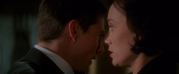 Movie still from “Mission: Impossible” (1996), directed by Brian De Palma – A man and a woman face to face in a dark room; Close Up shot, Over the shoulder angle