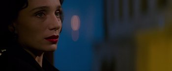 Movie still from “Mission: Impossible” (1996), directed by Brian De Palma – A person wearing a black shirt; Close Up shot, Over the shoulder angle