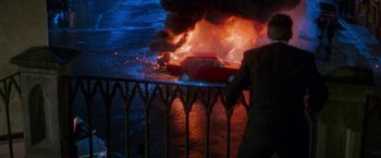 Movie still from “Mission: Impossible” (1996), directed by Brian De Palma – A car is on fire in the middle of the night; Wide shot, High angle