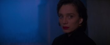 Movie still from “Mission: Impossible” (1996), directed by Brian De Palma – A person wearing a black shirt; Close Up shot, Over the shoulder angle