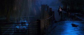 Movie still from “Mission: Impossible” (1996), directed by Brian De Palma – A person walking on a path near a fence; Extreme Wide shot, High angle