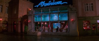Movie still from “Mission: Impossible” (1996), directed by Brian De Palma – A group of people standing in front of an aquarium; Extreme Wide shot, High angle