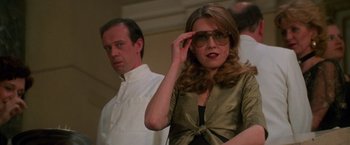 Movie still from “Mission: Impossible” (1996), directed by Brian De Palma – A man and a woman wearing glasses and a white shirt; Close Up shot, Low angle