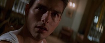Movie still from “Mission: Impossible” (1996), directed by Brian De Palma – A person's face in a dark room; Close Up shot, Low angle