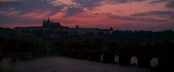 Movie still from “Mission: Impossible” (1996), directed by Brian De Palma – A view of a city at night from across a river; Extreme Wide shot, High angle