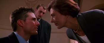 Movie still from “Mission: Impossible” (1996), directed by Brian De Palma – Two men and a woman talking to each other; Close Up shot, Over the shoulder angle