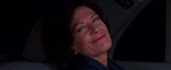 Movie still from “Mission: Impossible” (1996), directed by Brian De Palma – A person smiling; Close Up shot, Low angle