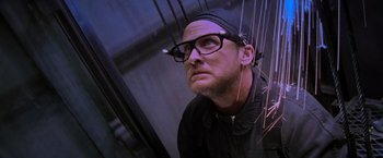 Movie still from “Mission: Impossible” (1996), directed by Brian De Palma – A man wearing glasses looking up at the ceiling; Close Up shot, Low angle