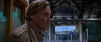 Movie still from “Mission: Impossible” (1996), directed by Brian De Palma – A person with long blonde hair; Close Up shot, Low angle