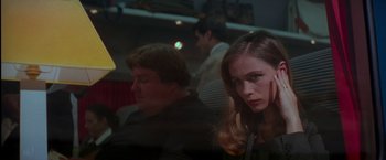 Movie still from “Mission: Impossible” (1996), directed by Brian De Palma – A woman and a man sitting next to each other in a room; Close Up shot, Over the shoulder angle