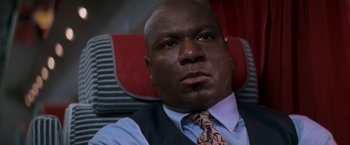 Movie still from “Mission: Impossible” (1996), directed by Brian De Palma – A person wearing a suit and tie; Close Up shot, High angle