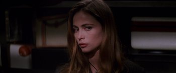 Movie still from “Mission: Impossible” (1996), directed by Brian De Palma – A beautiful young woman with long brown hair and blue eyes; Close Up shot, Over the shoulder angle