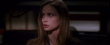 Movie still from “Mission: Impossible” (1996), directed by Brian De Palma – A person with long brown hair; Close Up shot, High angle