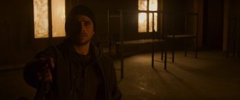 Movie still from “Mission: Impossible - Dead Reckoning Part One” (2023), directed by Christopher McQuarrie – A man standing in a dark room in front of a window; Medium shot, Low angle