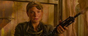 Movie still from “Mission: Impossible - Dead Reckoning Part One” (2023), directed by Christopher McQuarrie – A woman holding a gun while wearing military clothing; Close Up shot, High angle