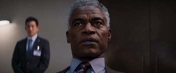 Movie still from “Mission: Impossible - Dead Reckoning Part One” (2023), directed by Christopher McQuarrie – An older black man wearing a suit and tie; Close Up shot, Low angle