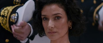 Movie still from “Mission: Impossible - Dead Reckoning Part One” (2023), directed by Christopher McQuarrie – A woman's face with a black curly hairstyle; Close Up shot, Over the shoulder angle
