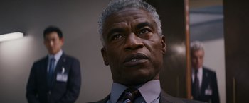 Movie still from “Mission: Impossible - Dead Reckoning Part One” (2023), directed by Christopher McQuarrie – An older black man wearing a suit and tie; Close Up shot, Low angle