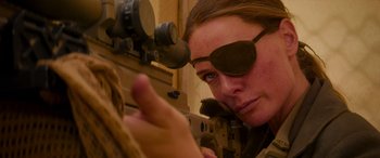 Movie still from “Mission: Impossible - Dead Reckoning Part One” (2023), directed by Christopher McQuarrie – A woman wearing eye glasses and holding a rifle; Close Up shot, Over the shoulder angle