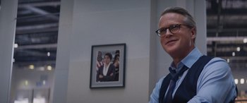 Movie still from “Mission: Impossible - Dead Reckoning Part One” (2023), directed by Christopher McQuarrie – A man standing in front of a picture of a woman; Medium shot, Over the shoulder angle