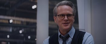 Movie still from “Mission: Impossible - Dead Reckoning Part One” (2023), directed by Christopher McQuarrie – A person wearing glasses and a tie; Close Up shot, Over the shoulder angle