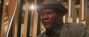 Movie still from “Mission: Impossible - Dead Reckoning Part One” (2023), directed by Christopher McQuarrie – An older man wearing a hat and a plaid shirt; Close Up shot, Low angle