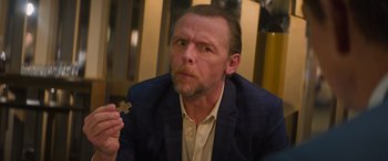 Movie still from “Mission: Impossible - Dead Reckoning Part One” (2023), directed by Christopher McQuarrie – A person holding a cross in his hand; Close Up shot, Over the shoulder angle