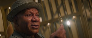 Movie still from “Mission: Impossible - Dead Reckoning Part One” (2023), directed by Christopher McQuarrie – An older man wearing a hat and holding a key; Extreme Close Up shot, Low angle