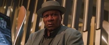 Movie still from “Mission: Impossible - Dead Reckoning Part One” (2023), directed by Christopher McQuarrie – A person wearing a suit and a hat; Close Up shot, Low angle