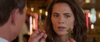 Movie still from “Mission: Impossible - Dead Reckoning Part One” (2023), directed by Christopher McQuarrie – A person holding a pair of clothespins; Close Up shot, Over the shoulder angle