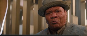 Movie still from “Mission: Impossible - Dead Reckoning Part One” (2023), directed by Christopher McQuarrie – An older man wearing a hat and a jacket; Close Up shot, Low angle