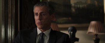 Movie still from “Mission: Impossible - Dead Reckoning Part One” (2023), directed by Christopher McQuarrie – A person wearing a suit and tie; Close Up shot, Over the shoulder angle