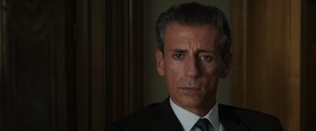 Movie still from “Mission: Impossible - Dead Reckoning Part One” (2023), directed by Christopher McQuarrie – A person wearing a suit and tie; Close Up shot, Over the shoulder angle