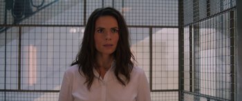 Movie still from “Mission: Impossible - Dead Reckoning Part One” (2023), directed by Christopher McQuarrie – A woman in a white shirt is standing in front of a window; Close Up shot, Low angle