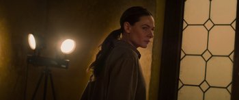 Movie still from “Mission: Impossible - Dead Reckoning Part One” (2023), directed by Christopher McQuarrie – A woman standing in front of a wall with her hair in a pony tail; Close Up shot, Low angle