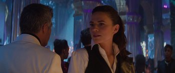 Movie still from “Mission: Impossible - Dead Reckoning Part One” (2023), directed by Christopher McQuarrie – A woman in a black and white dress shirt and tie; Close Up shot, Over the shoulder angle