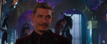 Movie still from “Mission: Impossible - Dead Reckoning Part One” (2023), directed by Christopher McQuarrie – A person wearing a suit and tie; Close Up shot, Over the shoulder angle