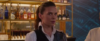 Movie still from “Mission: Impossible - Dead Reckoning Part One” (2023), directed by Christopher McQuarrie – A woman standing in front of a wall of bottles; Close Up shot, Over the shoulder angle