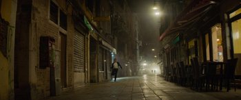 Movie still from “Mission: Impossible - Dead Reckoning Part One” (2023), directed by Christopher McQuarrie – A man running down a street at night; Extreme Wide shot, Low angle