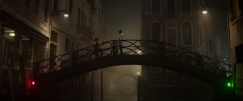 Movie still from “Mission: Impossible - Dead Reckoning Part One” (2023), directed by Christopher McQuarrie – Two people are standing on a bridge in the fog; Extreme Wide shot, Low angle