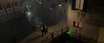 Movie still from “Mission: Impossible - Dead Reckoning Part One” (2023), directed by Christopher McQuarrie – A man walking down a stair way near a body of water at night; Extreme Wide shot, High angle