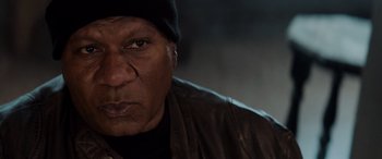 Movie still from “Mission: Impossible - Dead Reckoning Part One” (2023), directed by Christopher McQuarrie – An older man wearing a leather jacket and a hat; Close Up shot, Low angle