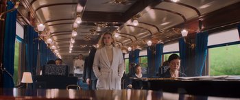 Movie still from “Mission: Impossible - Dead Reckoning Part One” (2023), directed by Christopher McQuarrie – A woman in a white coat standing in a train; Wide shot, Low angle